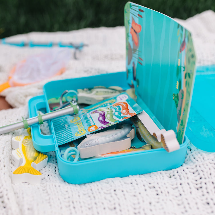 A kid playing with The Melissa & Doug Let’s Explore Fishing Play Set – 21 Pieces