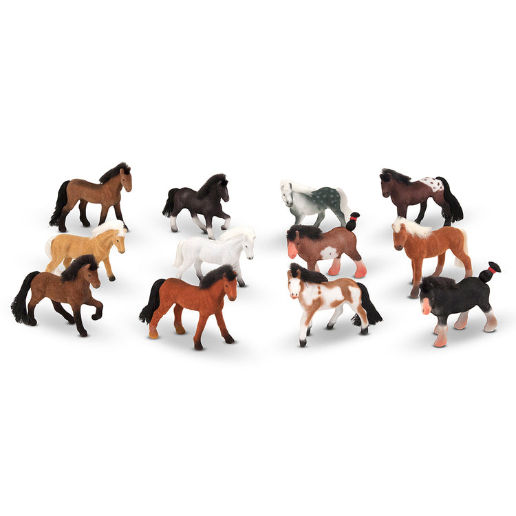 A kid playing with The Melissa & Doug Pasture Pals - 12 Collectible Horses With Wooden Barn-Shaped Crate