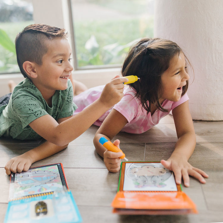 A kid playing with The Melissa & Doug On the Go Water Wow! Reusable Water-Reveal Connect the Dots Activity Pad – Safari