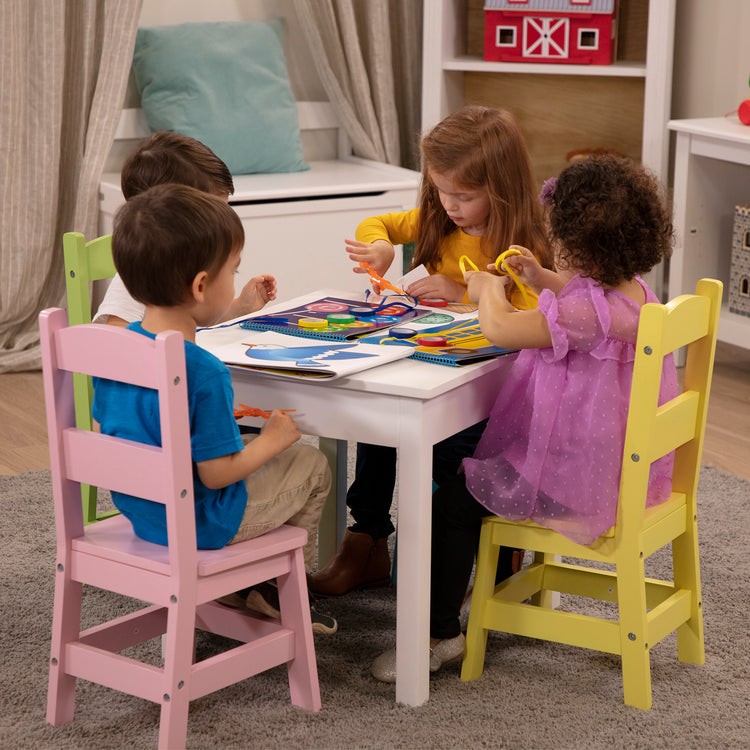 A kid playing with The Melissa & Doug Scissor Skills and Tape Activity Books Set