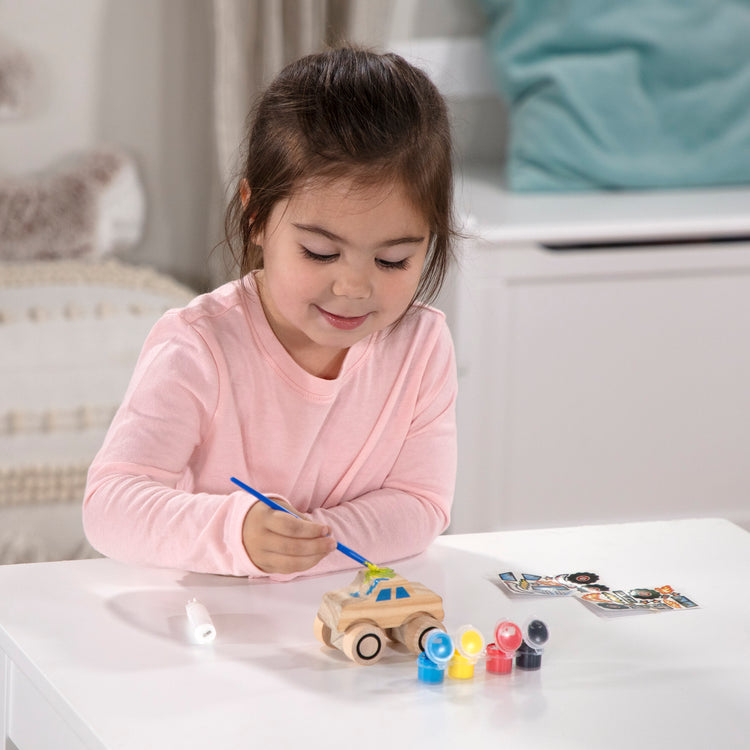 A kid playing with The DYO Bundle - Monster Truck & Train