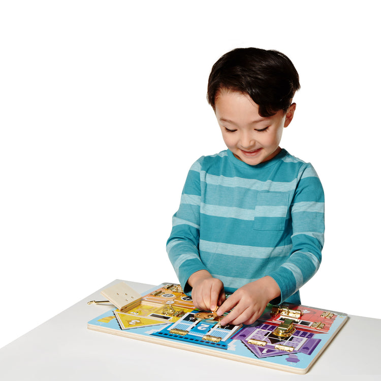 A child on white background with The Melissa & Doug Latches Wooden Activity Board