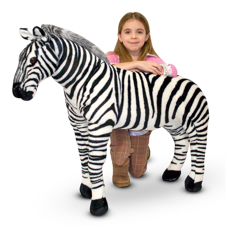 A child on white background with The Melissa & Doug Giant Striped Zebra - Lifelike Stuffed Animal (nearly 3 feet tall)