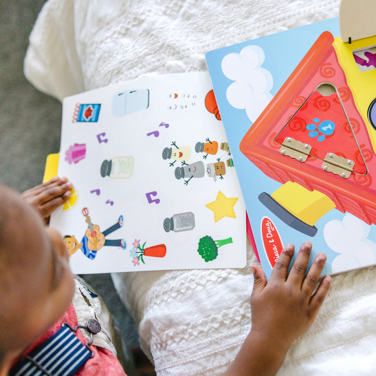 A kid playing with The Melissa & Doug Blue’s Clues & You! Wooden Activity Board with Clue Cards