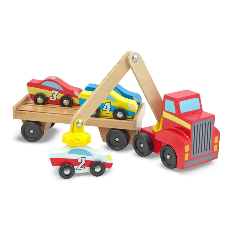 The loose pieces of The Melissa & Doug Magnetic Car Loader Wooden Toy Set With 4 Cars and 1 Semi-Trailer Truck