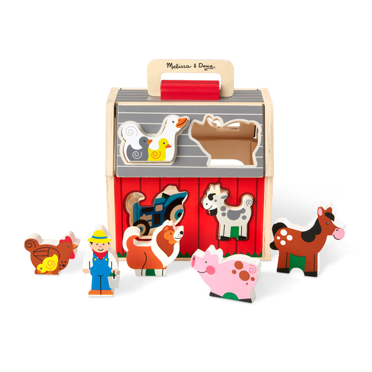 The loose pieces of The Melissa & Doug Wooden Take-Along Sorting Barn Toy with Flip-Up Roof and Handle 10 Wooden Farm Play Pieces