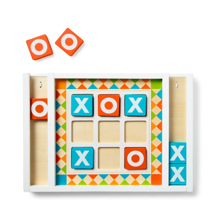The loose pieces of The Melissa & Doug Wooden Tic-Tac-Toe Board Game with 10 Self-Storing Wooden Game Pieces (12.5” W x 8.5” L x 1.25” D)