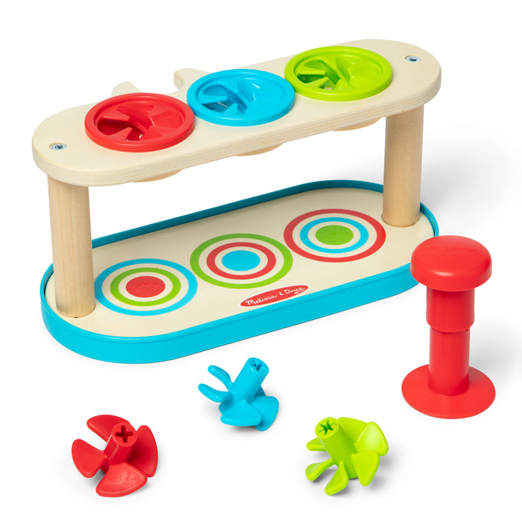 The loose pieces of The Melissa & Doug Match & Push Spinning Tops Wooden Developmental Skills Learning Toy for Girls and Boys 2+ 