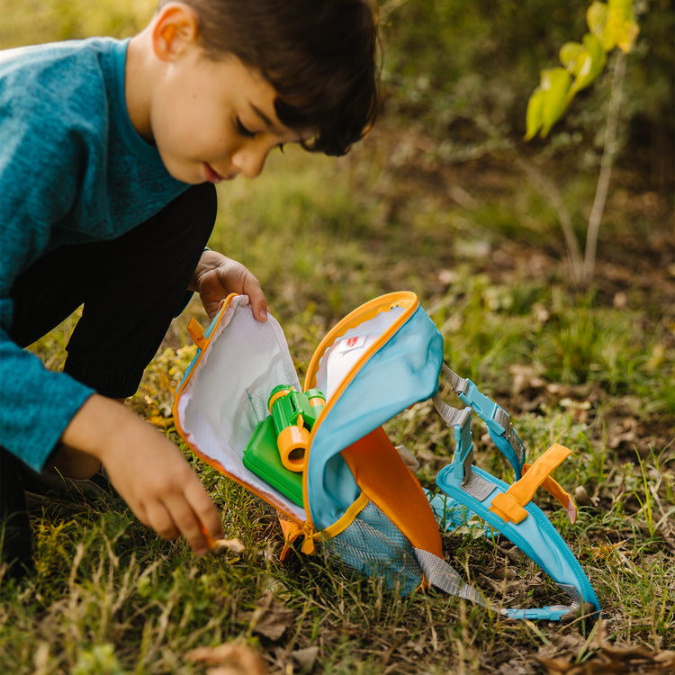 A kid playing with The Melissa & Doug Let’s Explore Hiking Play Set – 23 Pieces