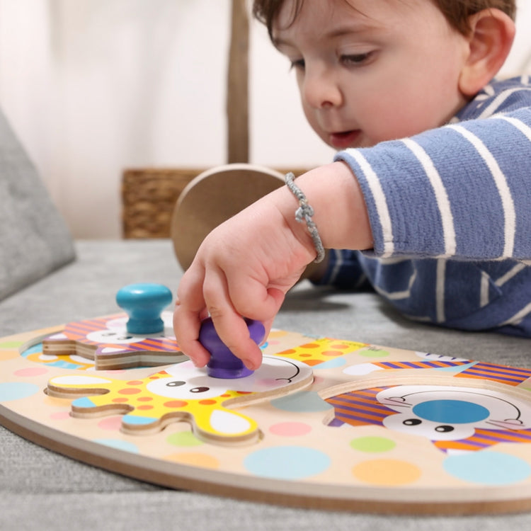 A kid playing with The Melissa & Doug First Play Wooden Jumbo Knob Safari Animal Puzzle (3 pcs)