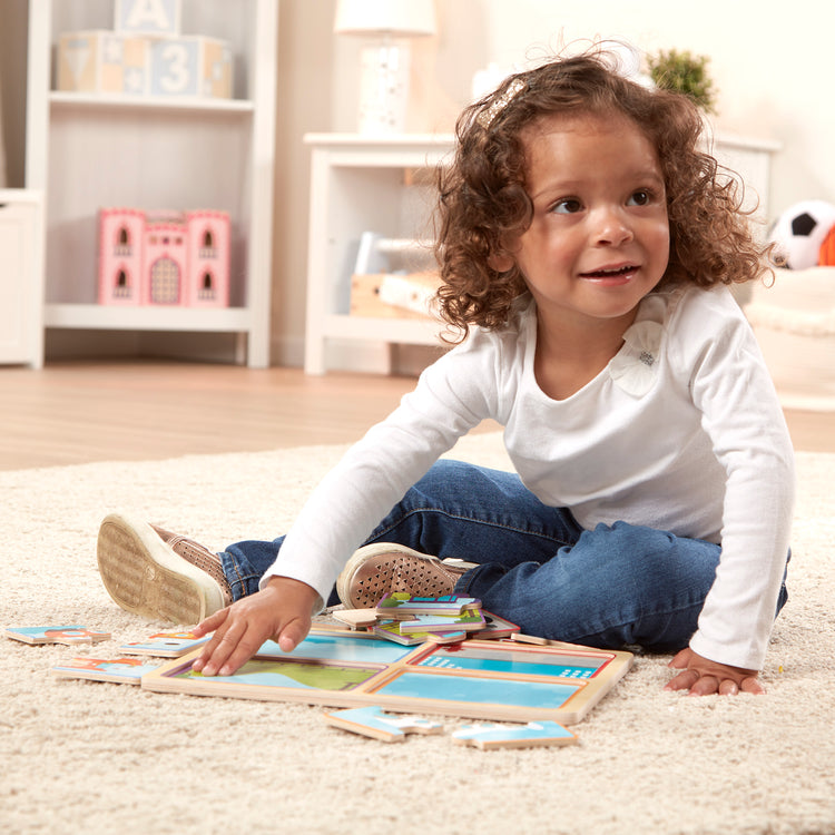 A kid playing with The Melissa & Doug Natural Play Wooden Puzzle: Ready, Set, Go (Four 4-Piece Vehicle Puzzles)