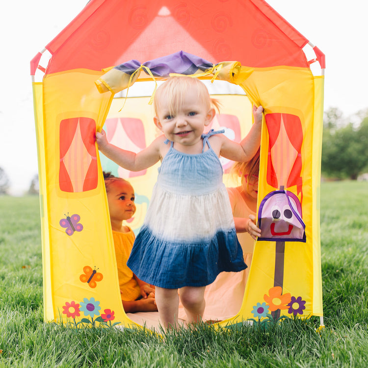 A kid playing with The Melissa & Doug Blue's Clues & You! Blue's House Play Tent