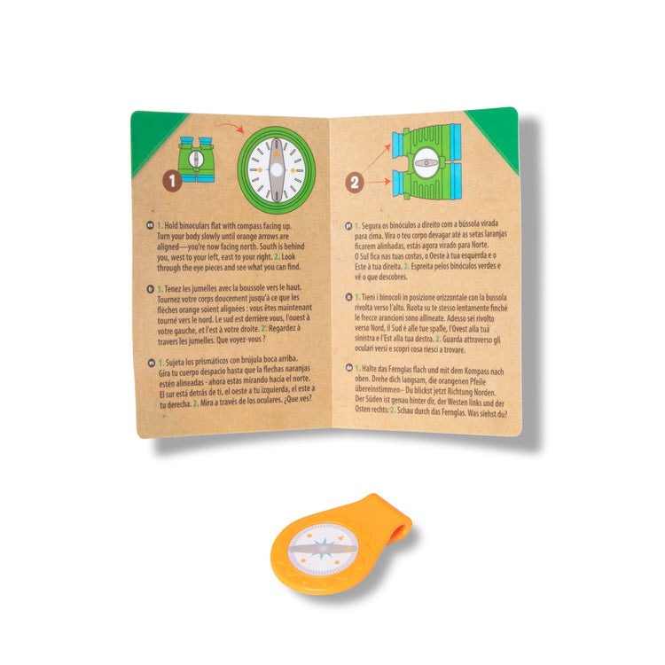 The loose pieces of The Melissa & Doug Let's Explore Binoculars & Compass Play Set