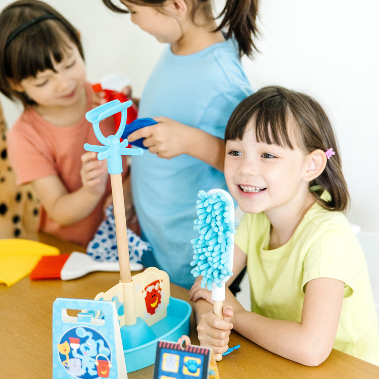 A kid playing with The Melissa & Doug Blue’s Clues & You! Clean-Up Time Play Set