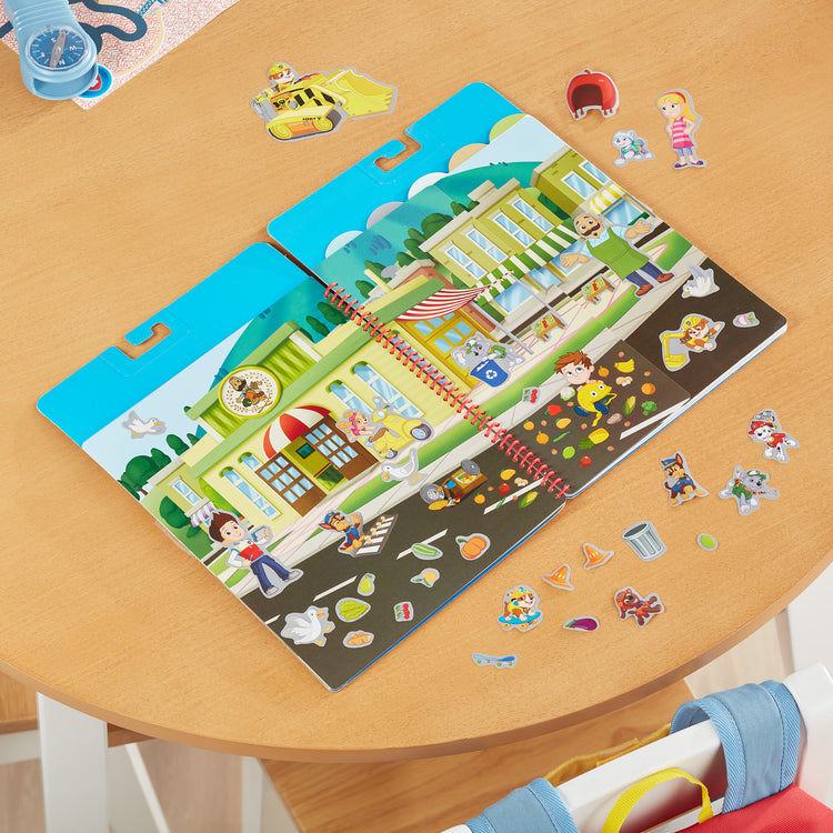 A playroom scene with The Melissa & Doug PAW Patrol Restickable Stickers Flip-Flap Pad - Adventure Bay (164 Reusable Stickers)