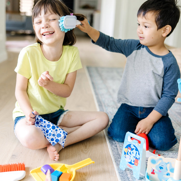 A kid playing with The Melissa & Doug Blue’s Clues & You! Clean-Up Time Play Set