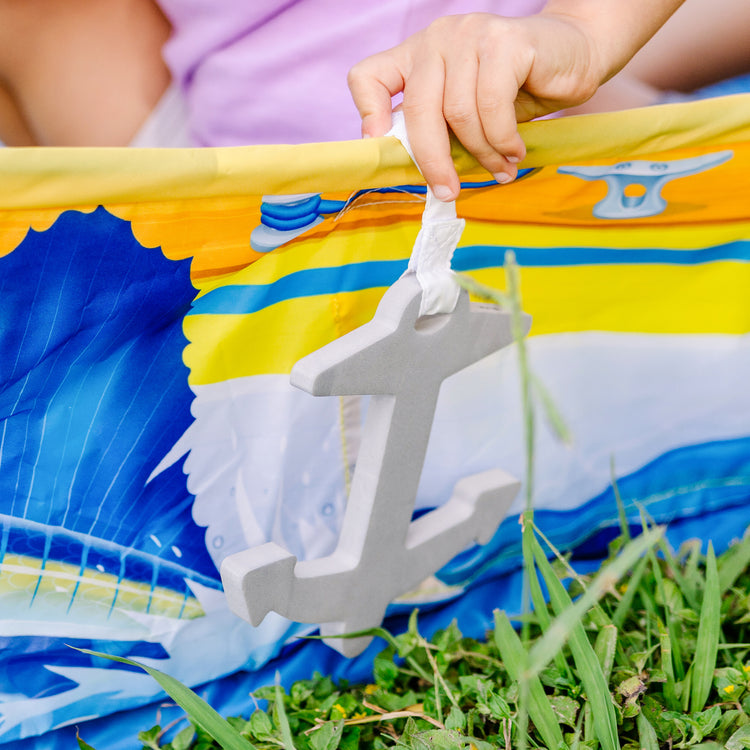 A kid playing with The Melissa & Doug Let’s Explore™ Sailboat Play Set