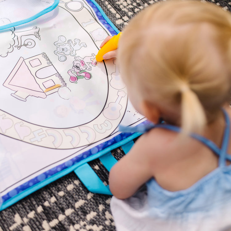 A kid playing with The Melissa & Doug Blue's Clues & You! Water Wow! Activity Mat (20 Inches x 30 Inches) With Reusable Water Reveal Surface