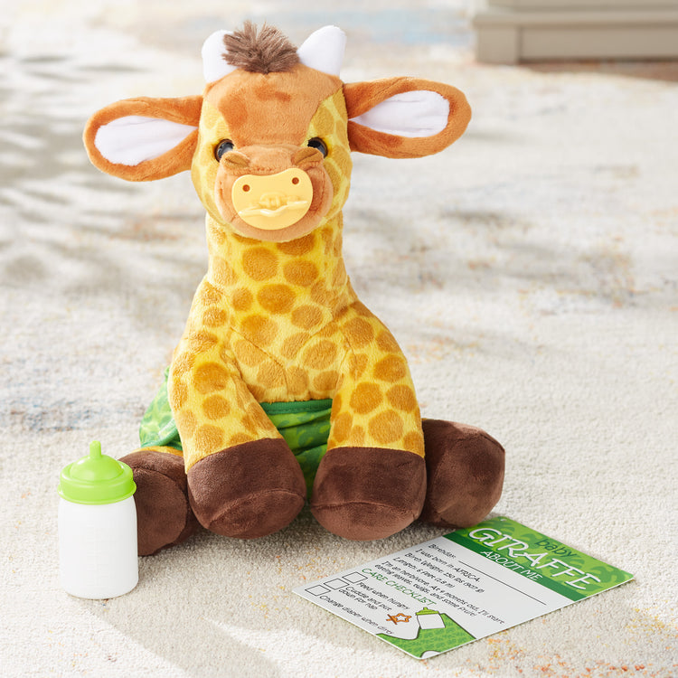 A playroom scene with The Melissa & Doug 11-Inch Baby Giraffe Plush Stuffed Animal with Pacifier, Diaper, Baby Bottle