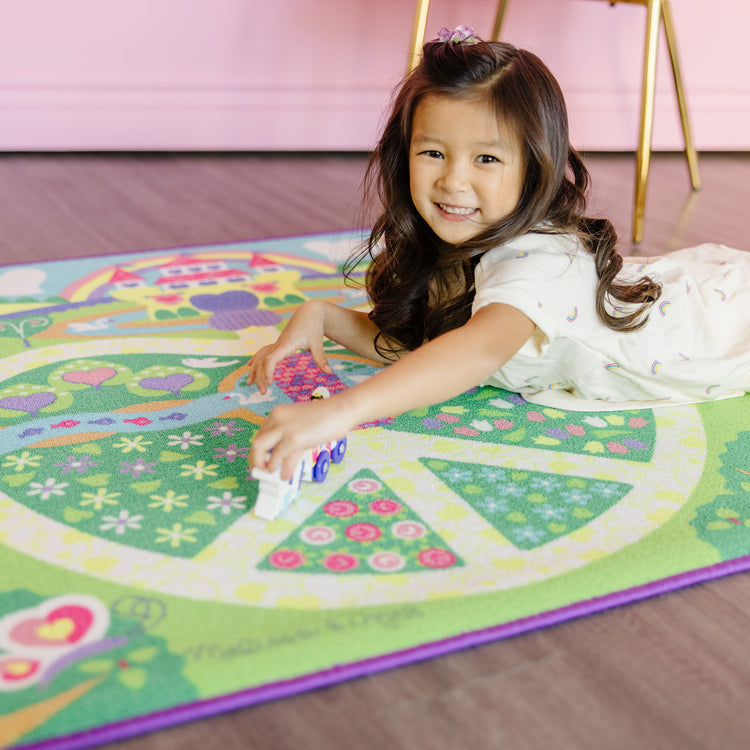 A kid playing with The Melissa & Doug Magical Kingdom Activity Rug Play Set – 4 Wooden Play Pieces