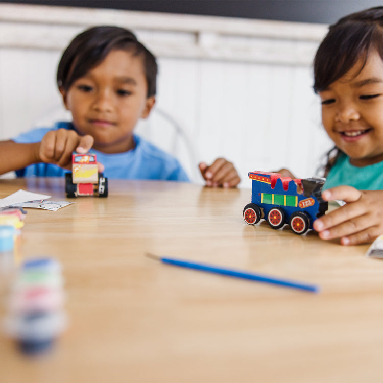 A kid playing with The DYO Bundle - Monster Truck & Train