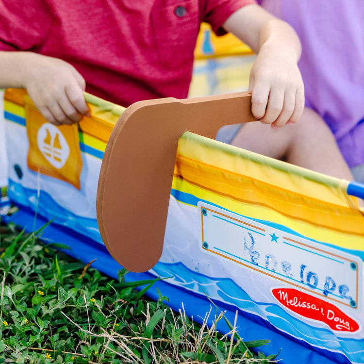 A kid playing with The Melissa & Doug Let’s Explore™ Sailboat Play Set