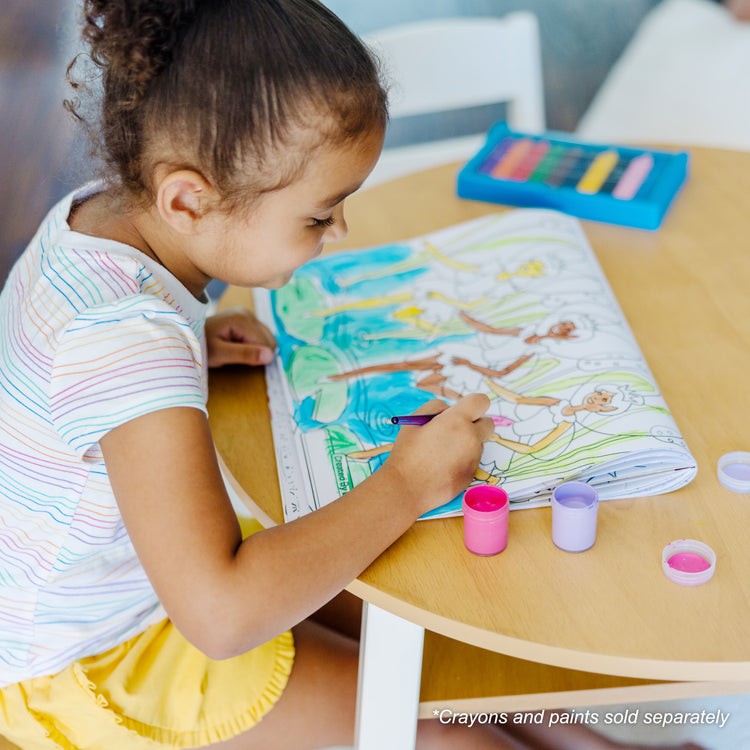 A kid playing with The Melissa & Doug Jumbo 50-Page Kids' Coloring Pad Activity Book - Princess and Fairy