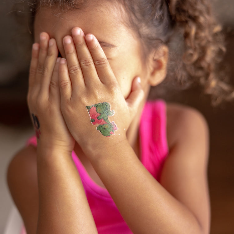 A kid playing with The My First Temporary Tattoos - Pink