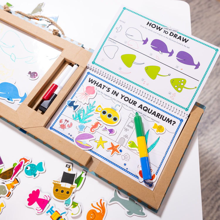 A playroom scene with The Melissa & Doug Natural Play: Play, Draw, Create Reusable Drawing & Magnet Kit – Ocean (42 Magnets, 5 Dry-Erase Markers)