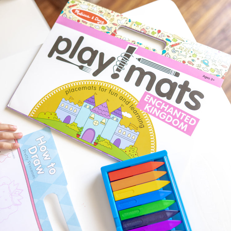 A kid playing with The Melissa & Doug Playmats Enchanted Kingdom Take-Along Paper Coloring And Learning Activity Pads (24 Pages)