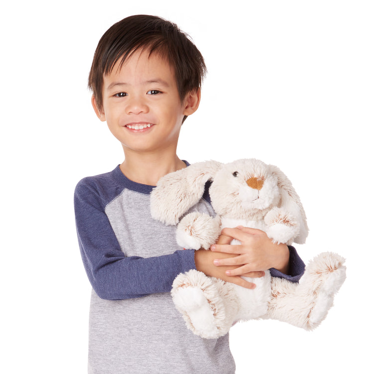 A kid playing with The Melissa & Doug Burrow Bunny Rabbit Stuffed Animal (9 inches)