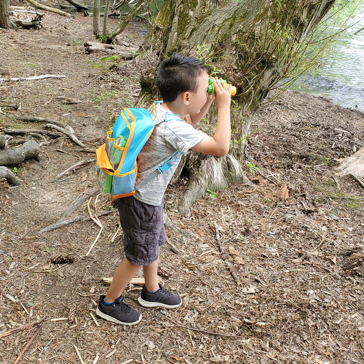 A kid playing with The Melissa & Doug Let’s Explore Hiking Play Set – 23 Pieces