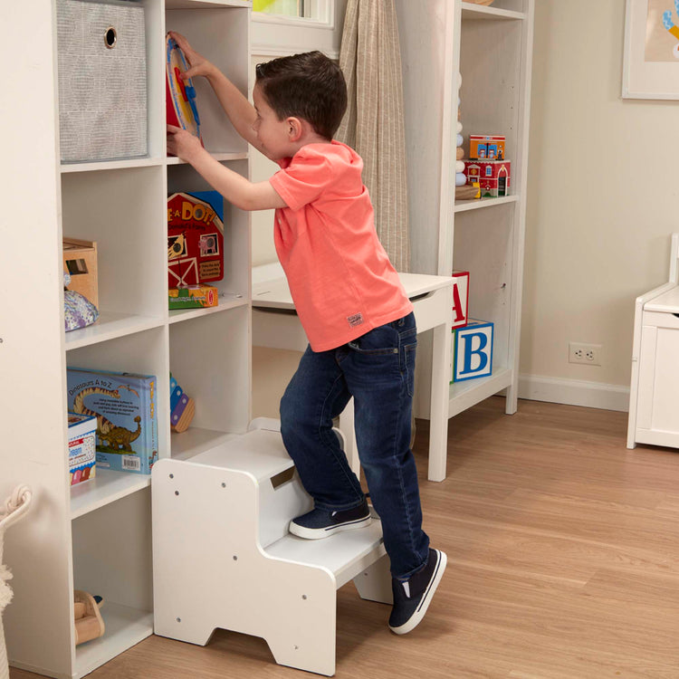 A kid playing with The Melissa & Doug Kids Wooden Step Stool - White