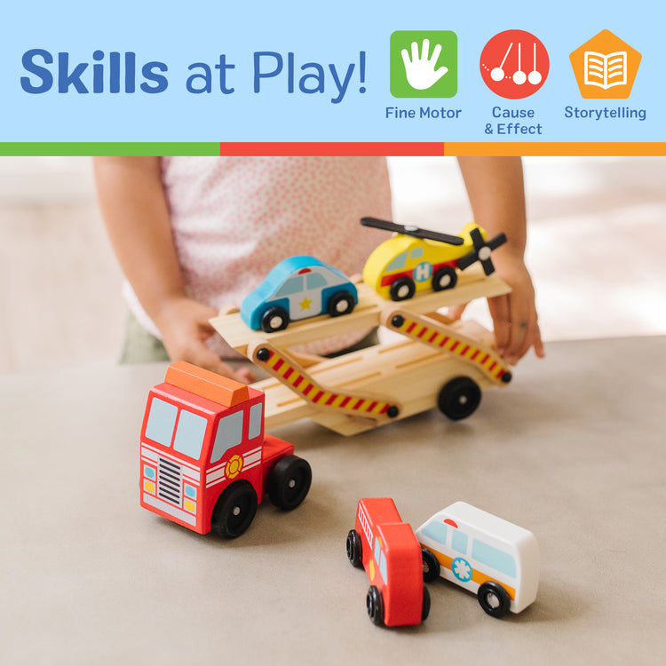 A kid playing with The Melissa & Doug Emergency Vehicle Carrier Wooden Truck With 4 Rescue Vehicles