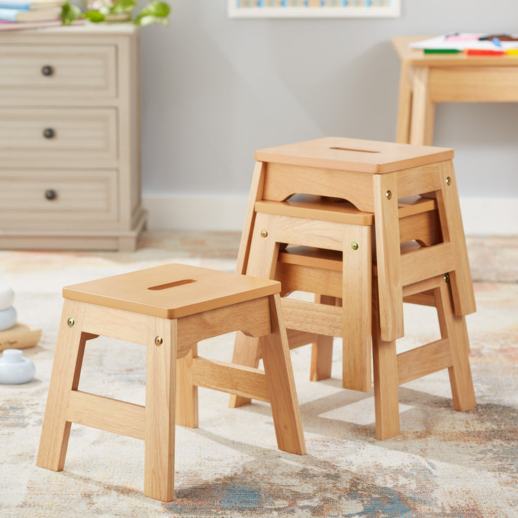 A playroom scene with The Melissa & Doug Wooden Stools – Set of 4 Stackable, Portable 11-Inch-Tall Stools (Natural)