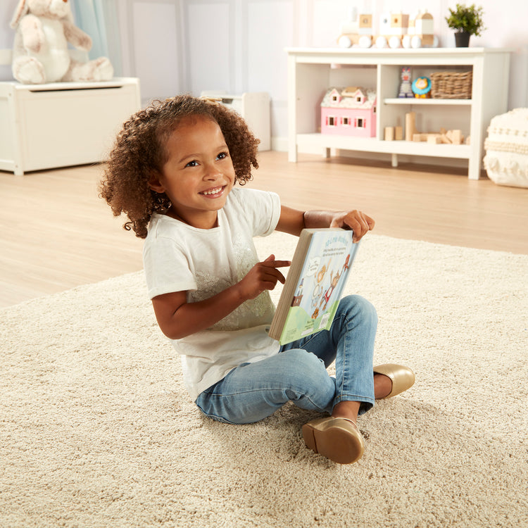 A kid playing with The Melissa & Doug Children's Book - Poke-a-Dot: 10 Little Monkeys (Board Book with Buttons to Pop)