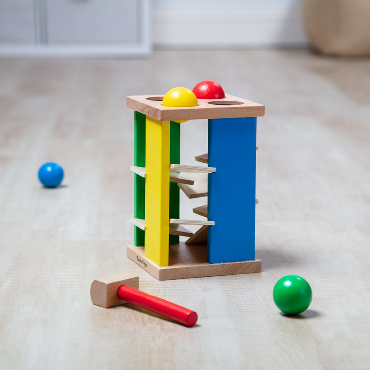 A playroom scene with The Melissa & Doug Deluxe Pound and Roll Wooden Tower Toy With Hammer