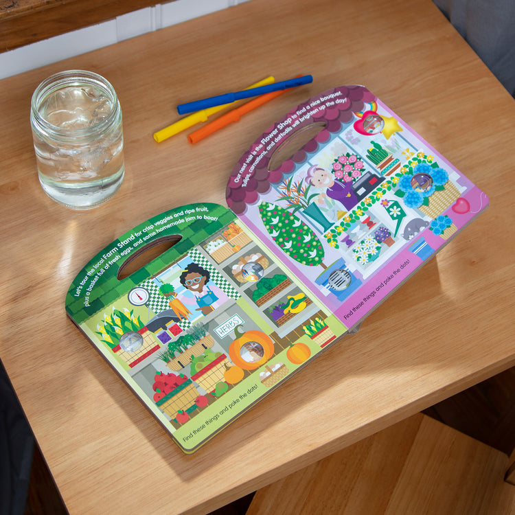 A playroom scene with The Melissa & Doug Children’s Book – Poke-a-Dot: All Around Our Town