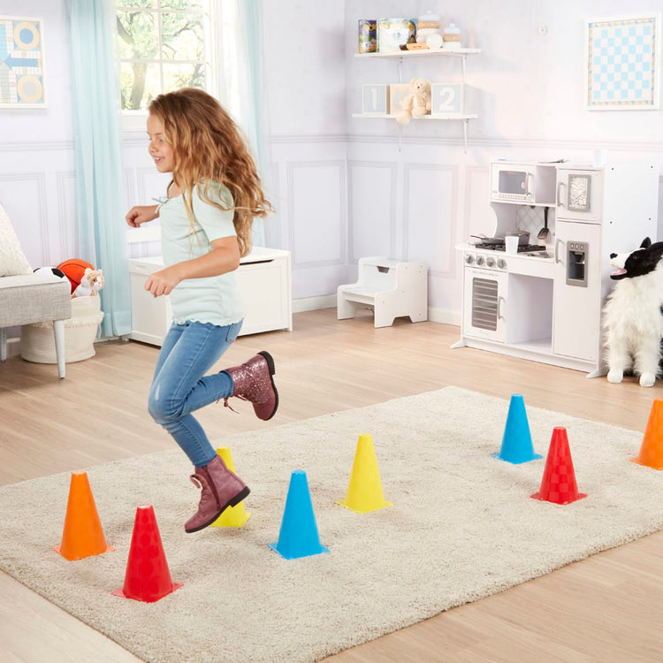 Multiple colour mini plastic safety cones on wooden surface