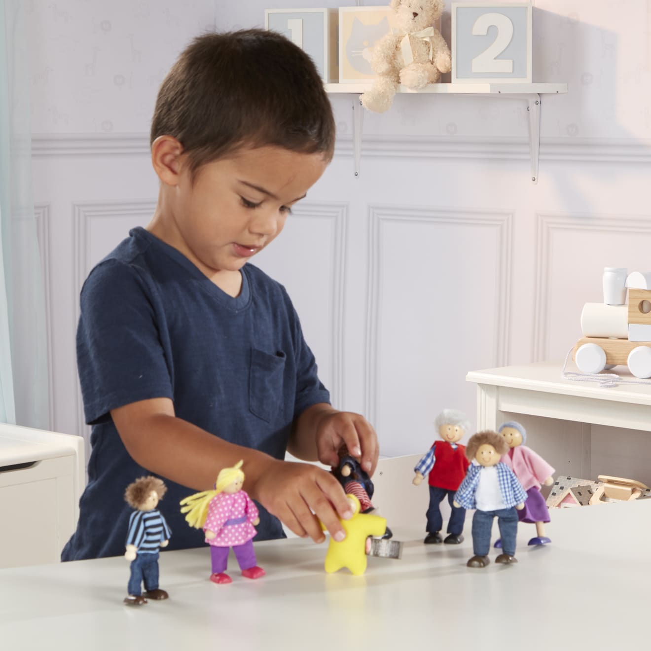 Wooden dolls house family deals with baby